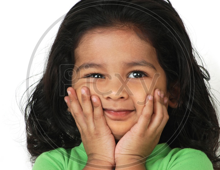 Indian little girl with her hands on the face