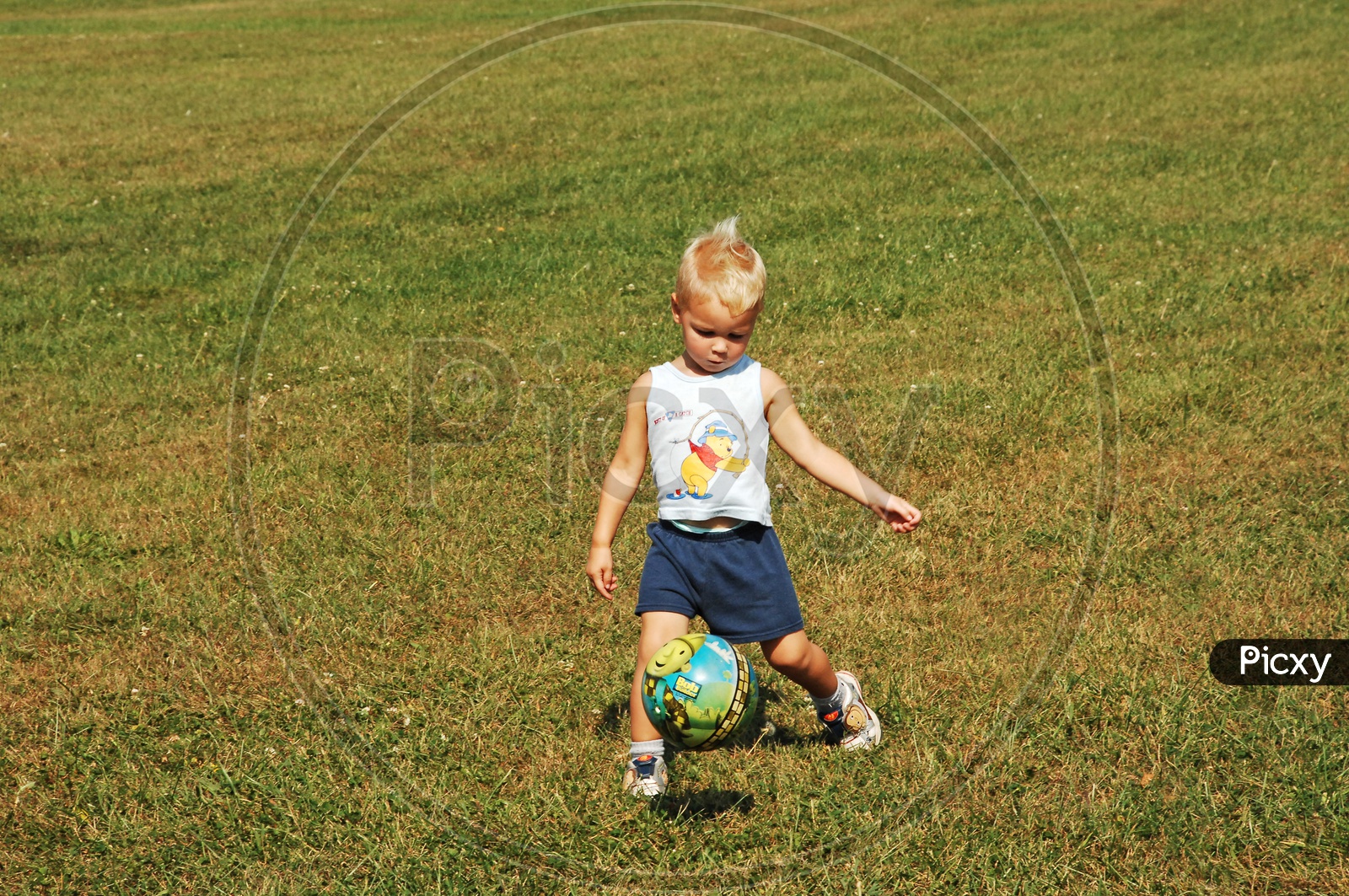 foreign kid playing with a ball