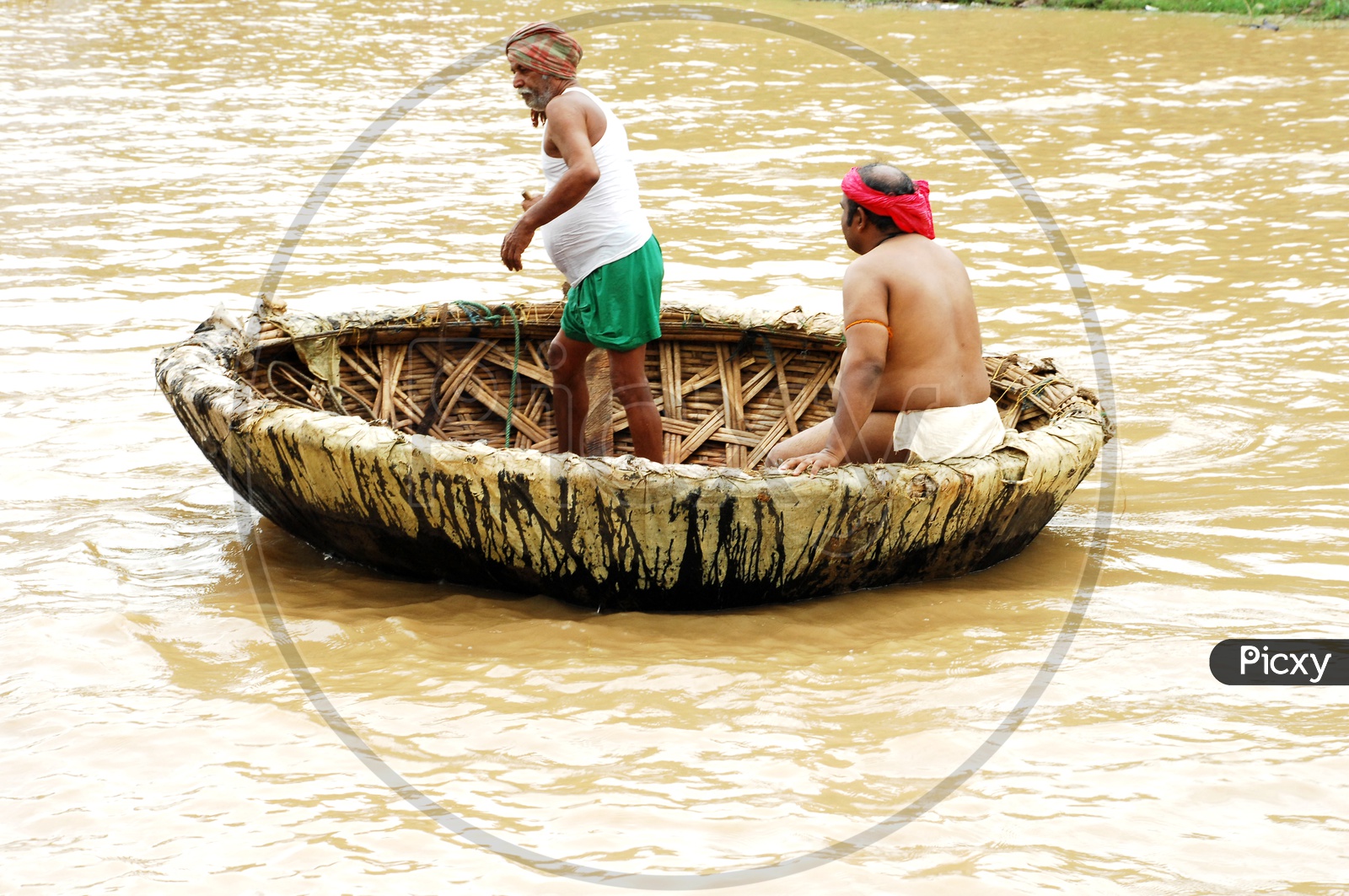 Indian People Sailing on Coracle