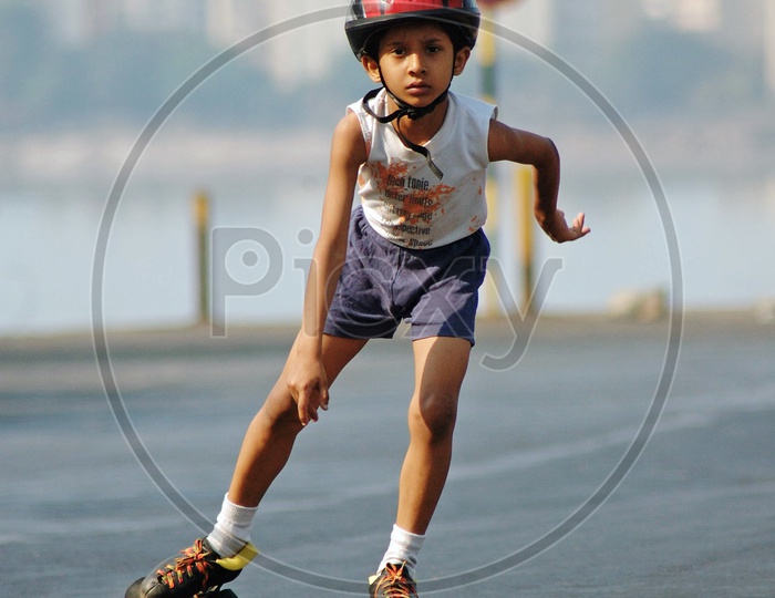 A boy skating on the road wearing a helmet