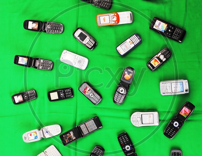 Mobile phones on green background