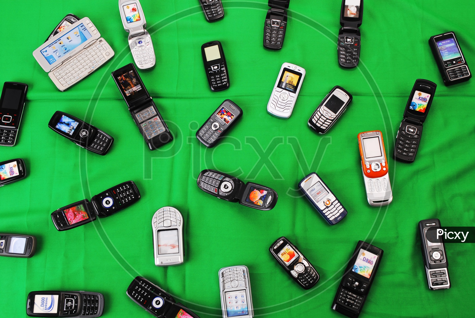Mobile phones on green background
