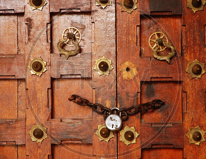 Wooden door locked with a chain