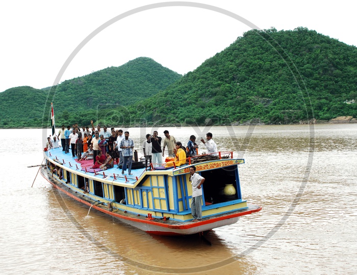 People traveling In a Boat with mountains in the background