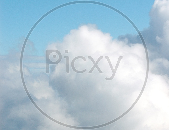 Man standing on top of the mountain with cloudy sky