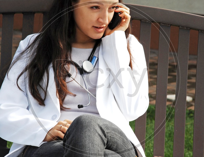 Foreign doctor speaking through a phone