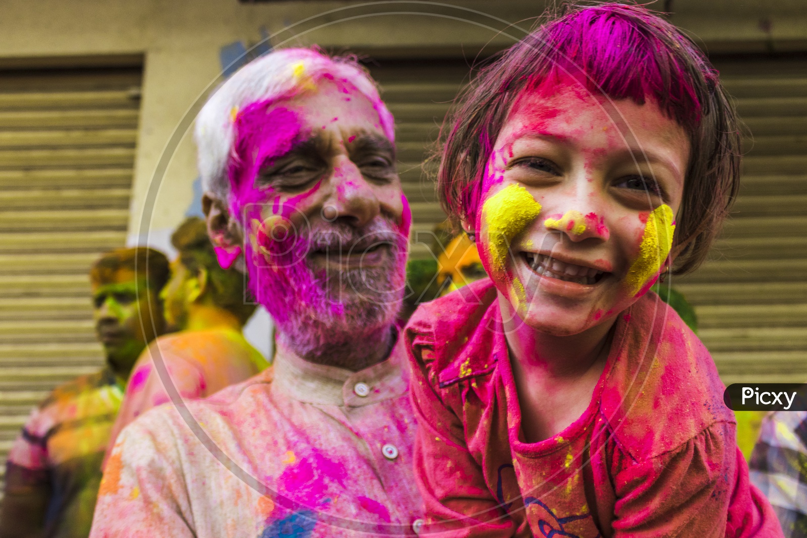 portaits of grand daughter and grand father on the day of holi