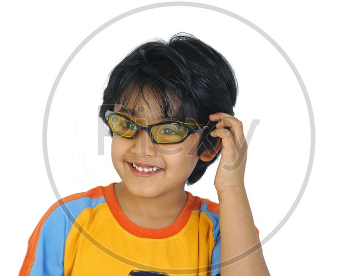 An Indian boy with specs smiling in white background