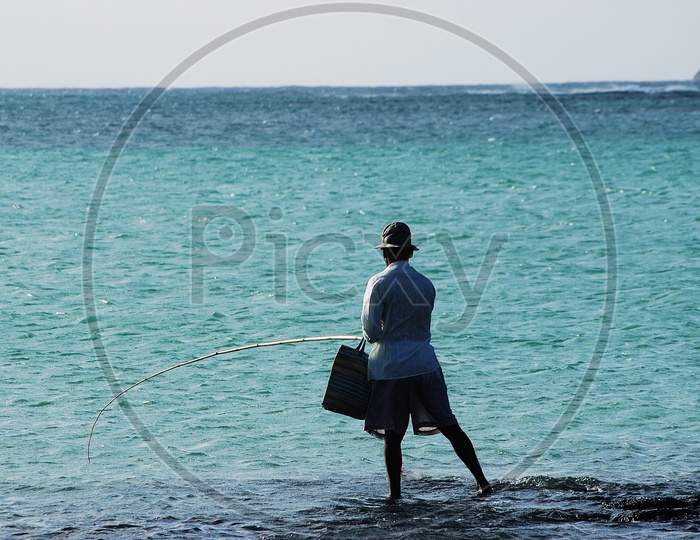 A man fishing by the sea