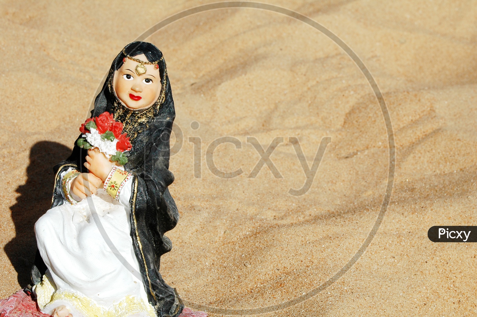 Figurine of a Muslim woman holding roses