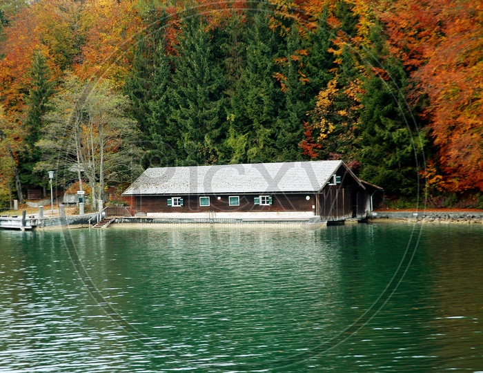 A house alongside the lake and Alpines