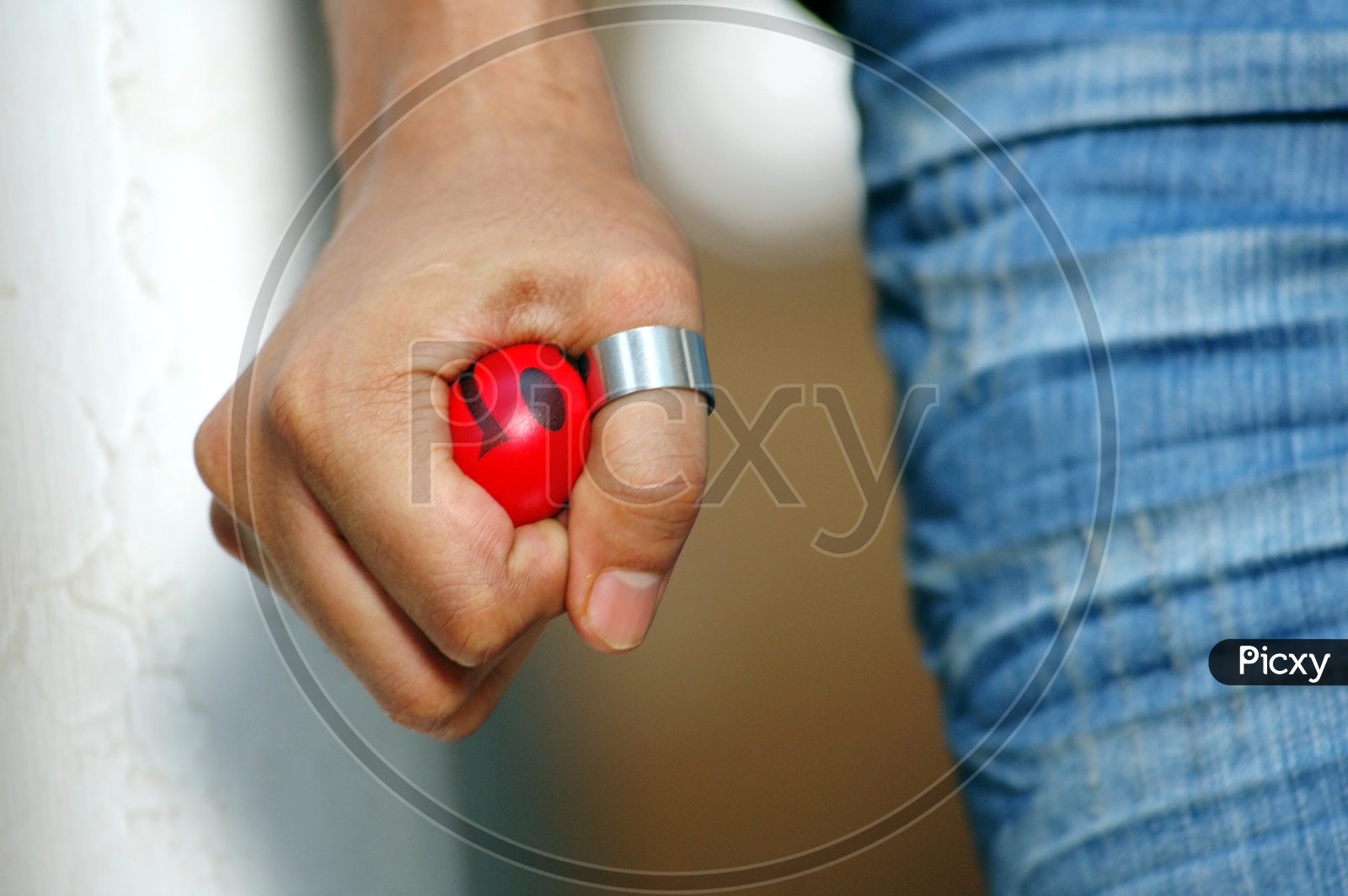 Man holding a red smiley ball