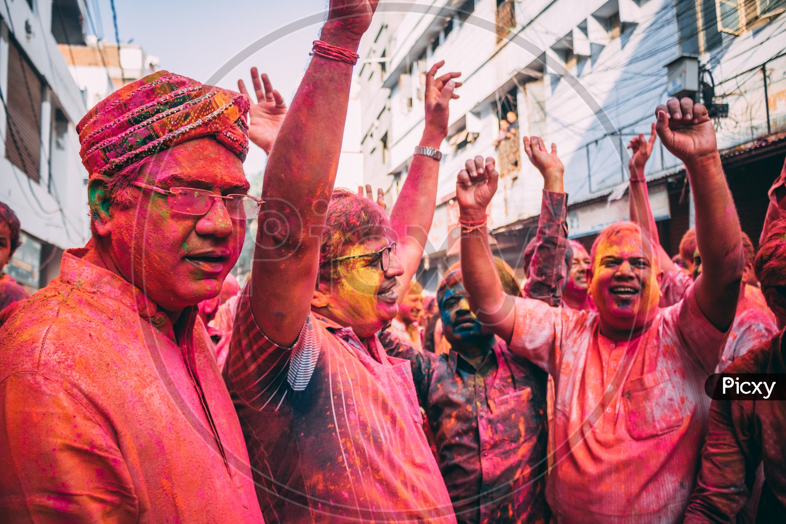 people happily dancing on the day of holi