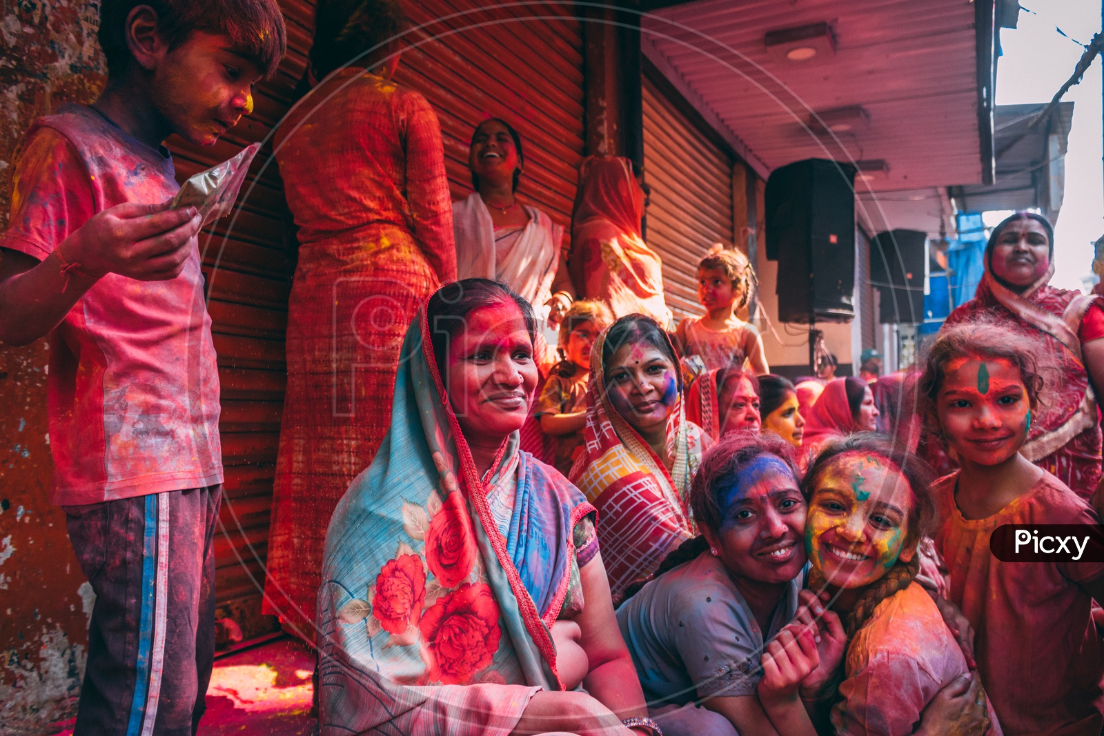 a group of people posing for picture on the day of holi