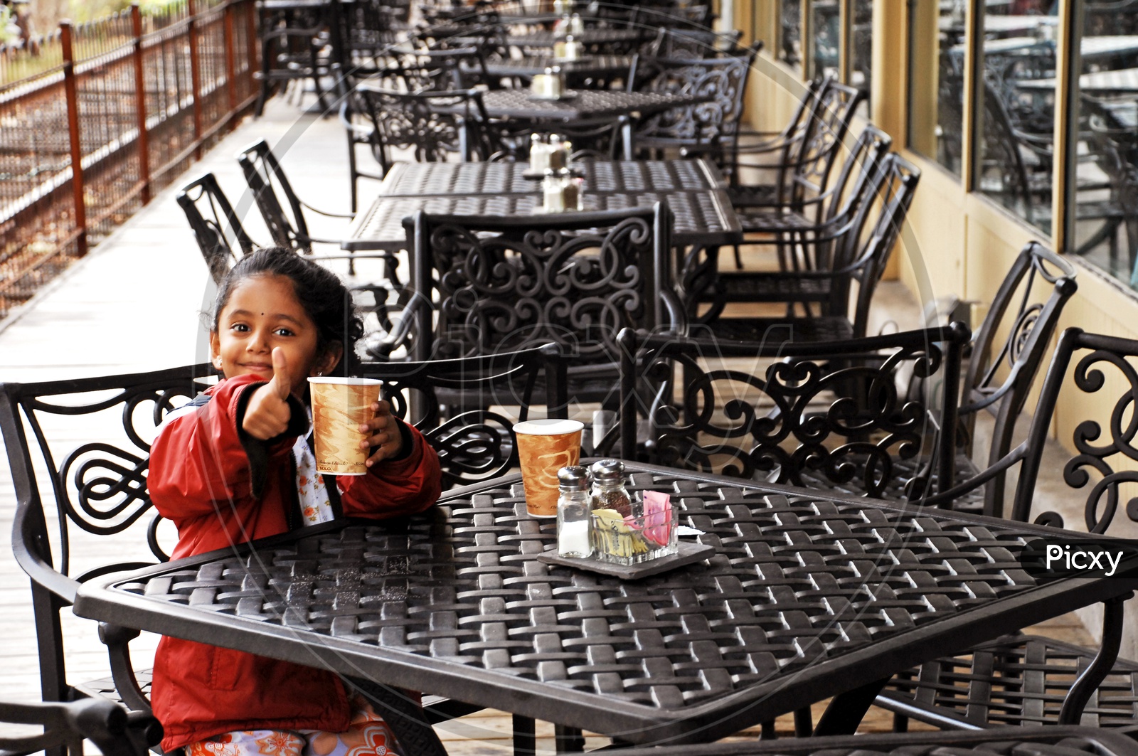 Indian little girl sitting in a cafe
