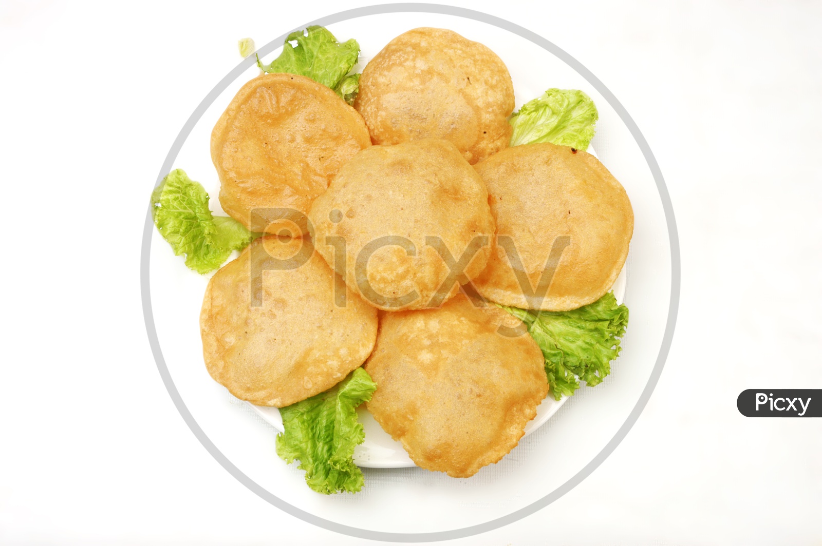 Indian breakfast Poori and lettuce in a white plate on white background