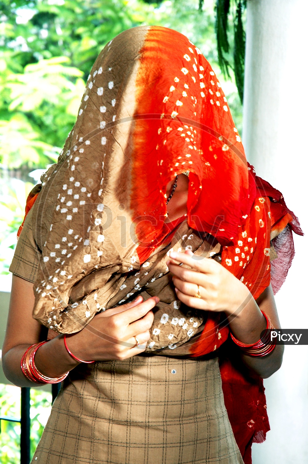 Indian Woman with her face covered with scarf