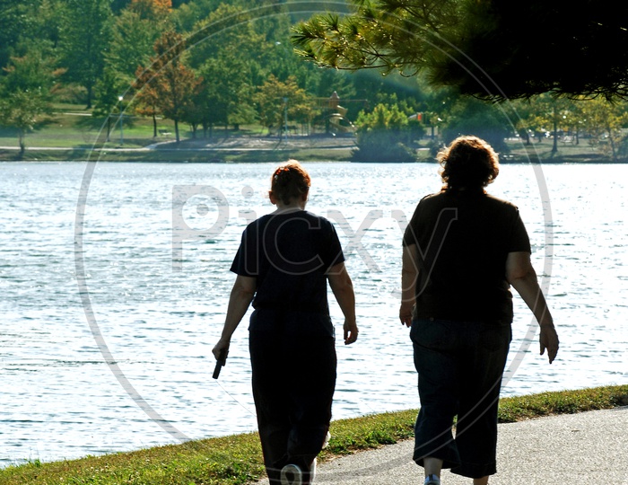 Two women going for a walk by the lake