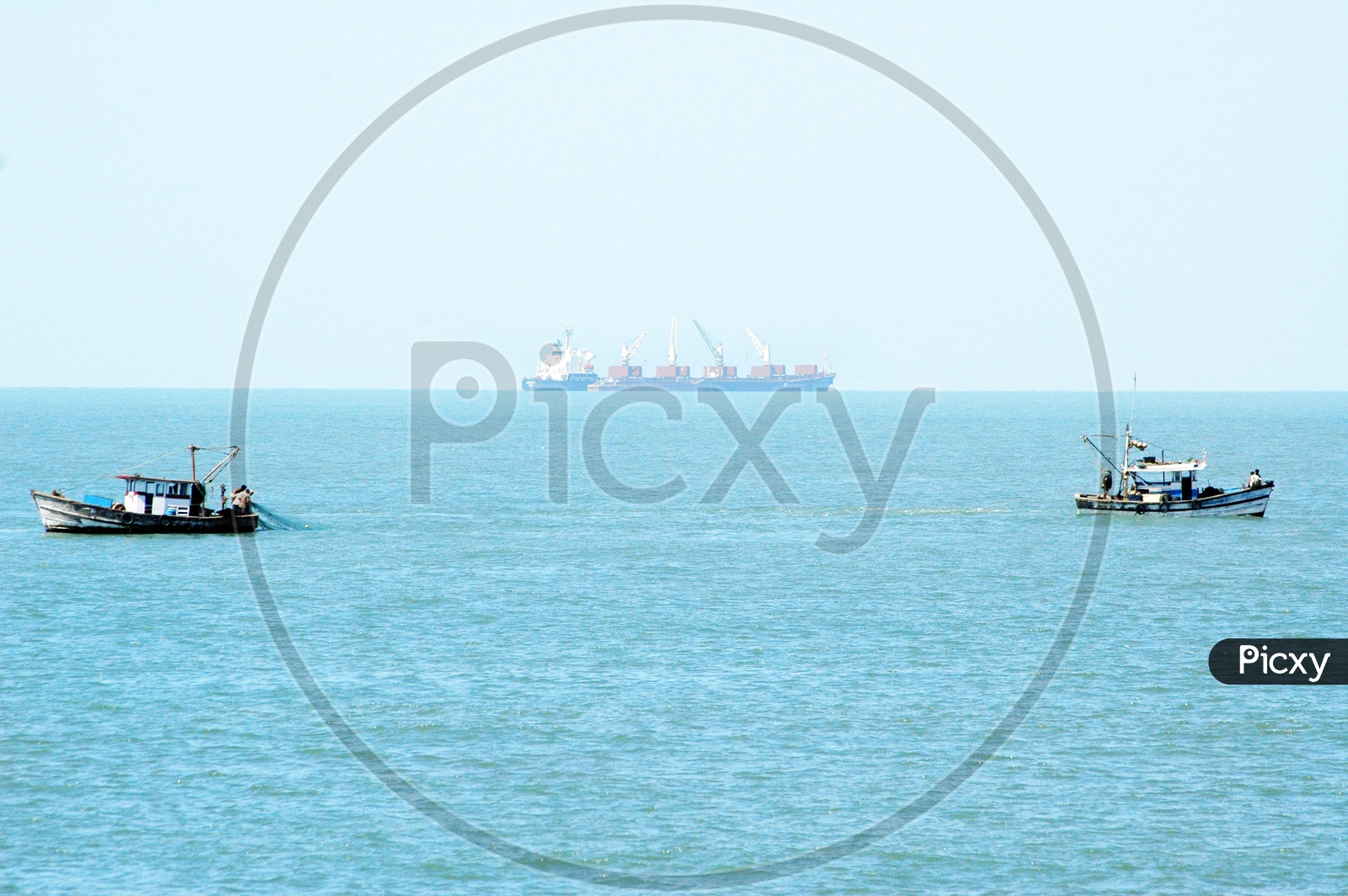 Fishing boats and a ship in the sea