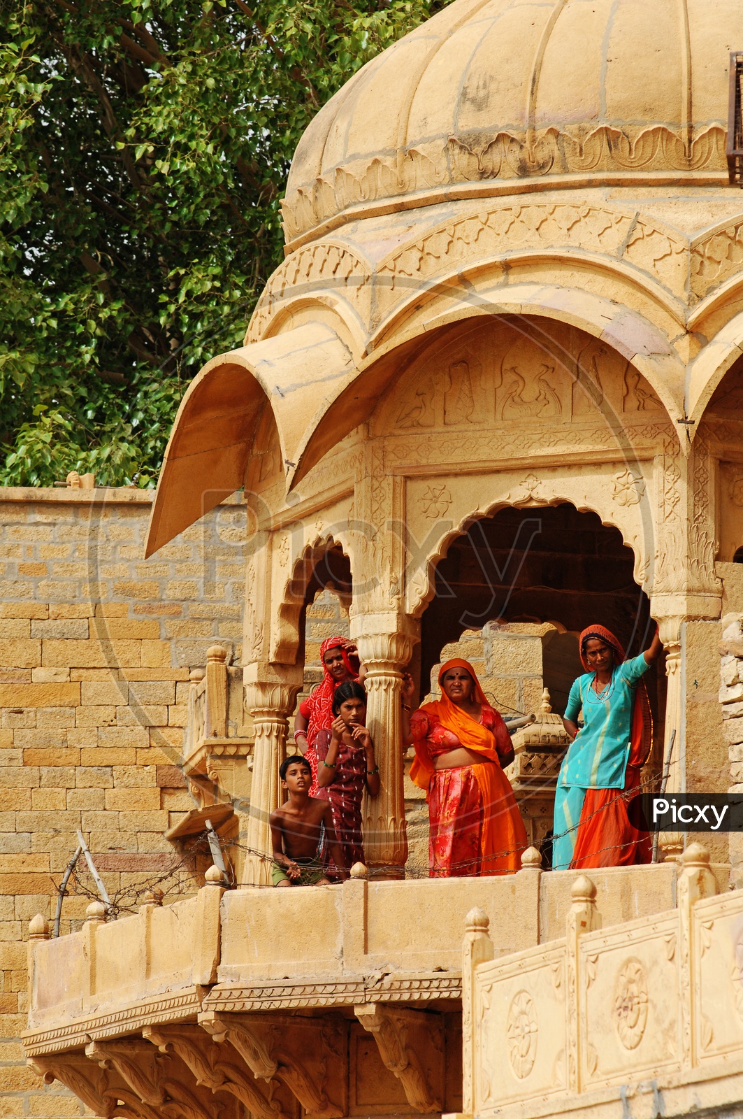 Rajasthani women standing alongside a dome