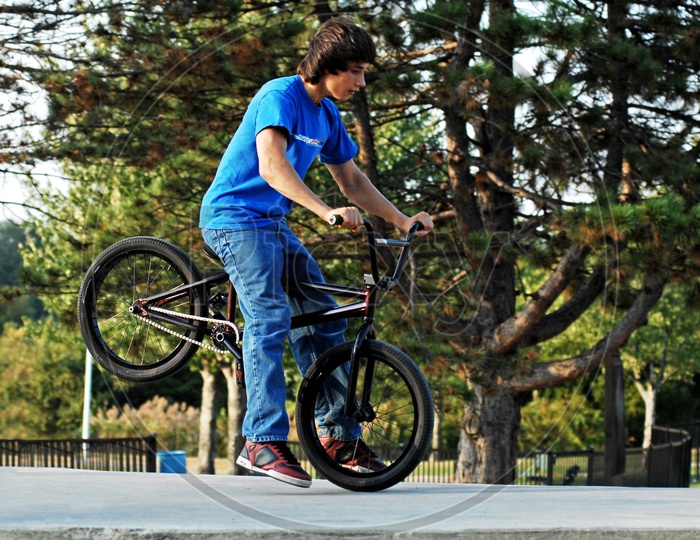 A Young boy riding BMX