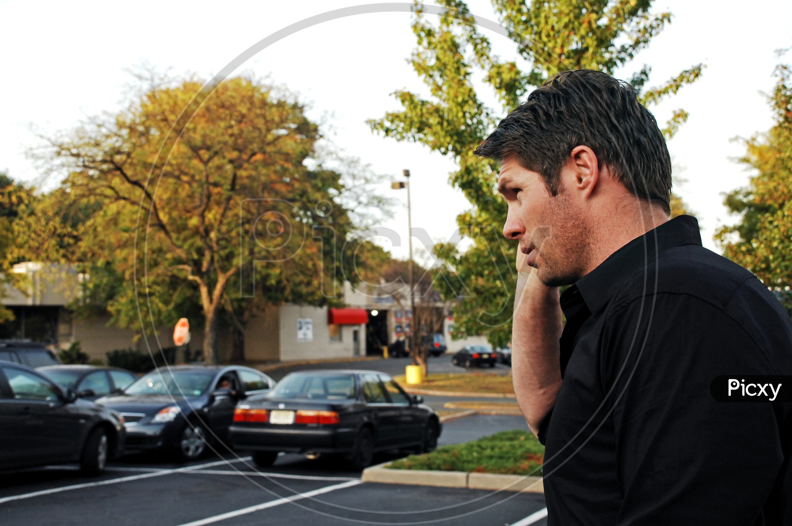 A man talking over a phone on the road