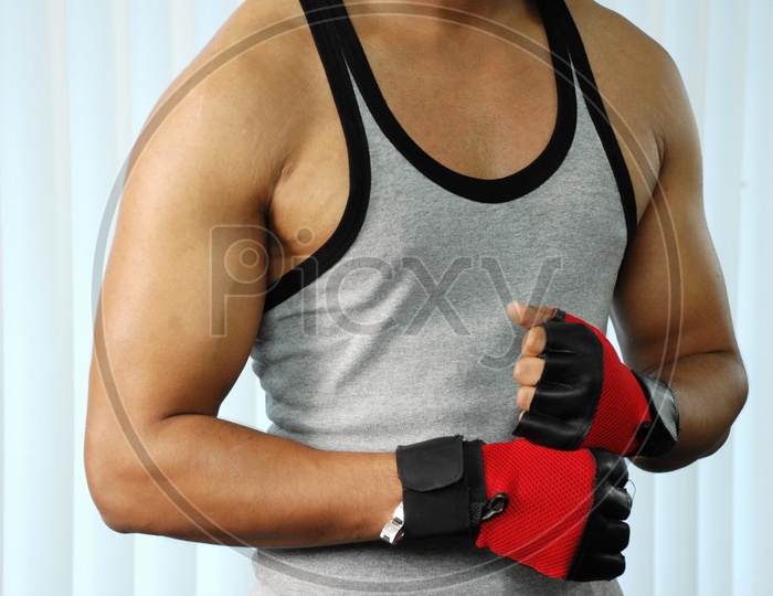 A man in a vest and gloves