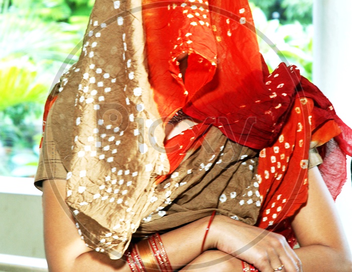 Indian Woman with her face covered with scarf
