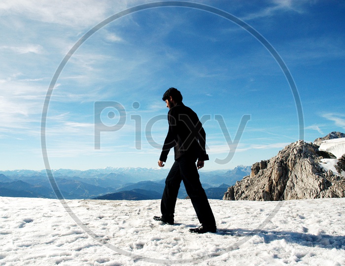 A man walking in the snow in Swiss Alps
