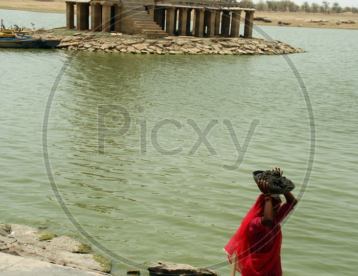 Rajasthani woman carrying cement and sand mixture