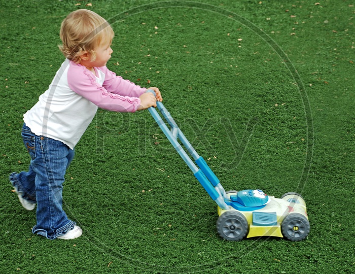 Little kid with lawn mover