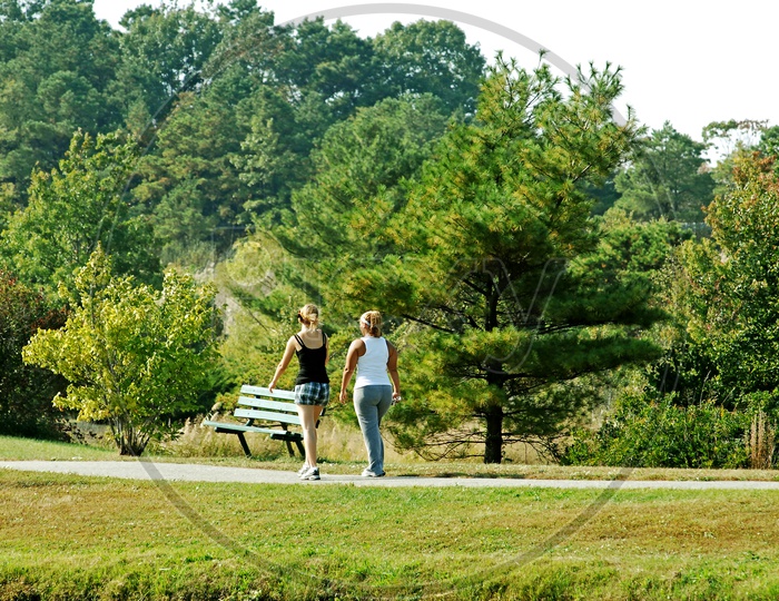 Two women going for a walk in the park