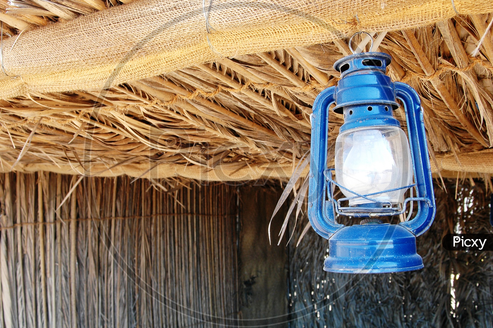 Blue lantern hanging onto a roof