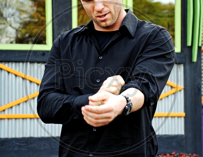 A male model in black shirt and blue jeans on the road