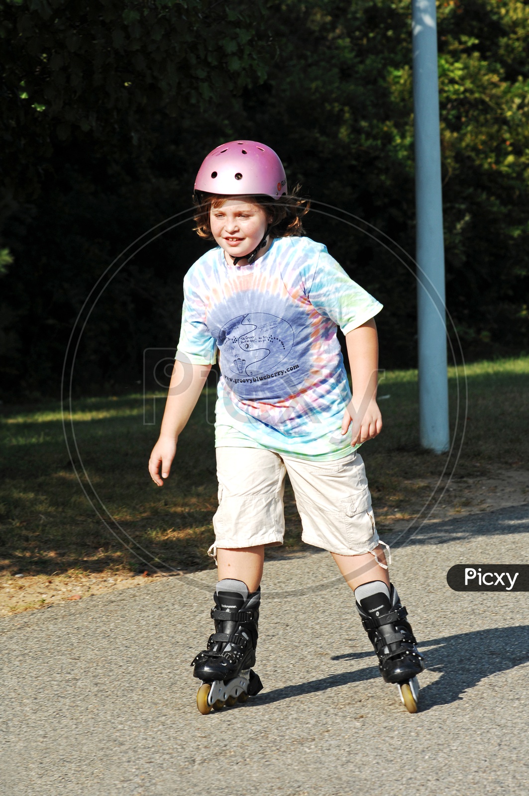 Image of Young boy wearing safety helmet roller skatingZL904785Picxy