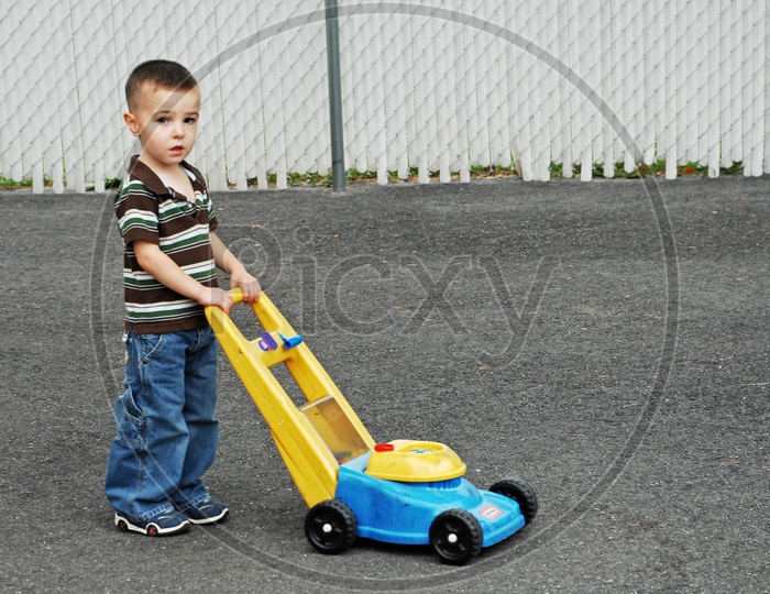 A Young Boy Playing With A Trolly Toy