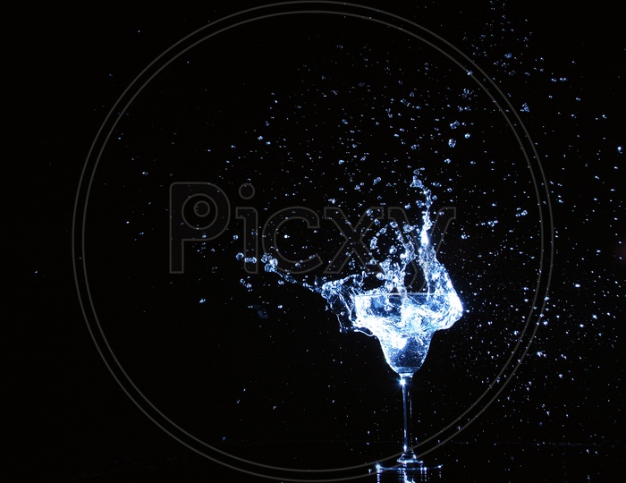 Splash of water in glass with black background