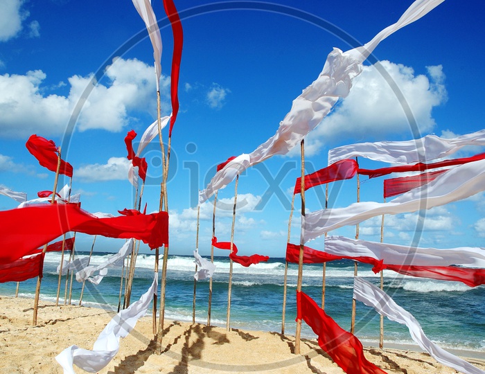 Curtains tied to sticks alongside the beach