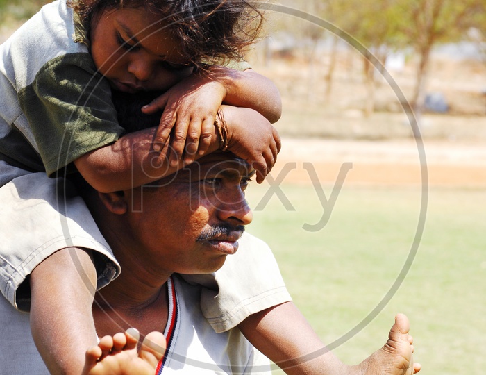 Father carrying child on his shoulders