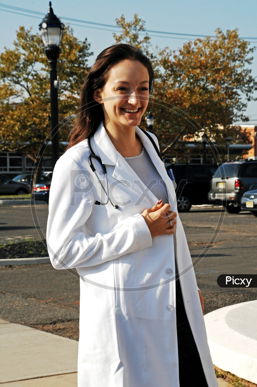 An young female doctor smiling on the road