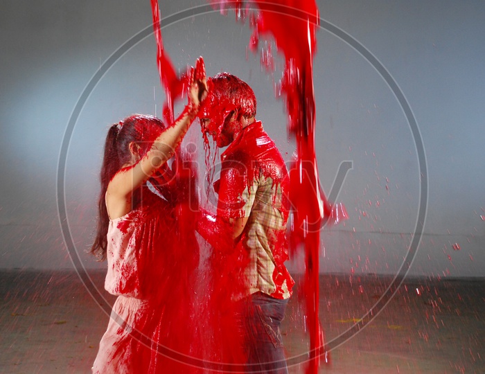 A couple dancing in dripping colours
