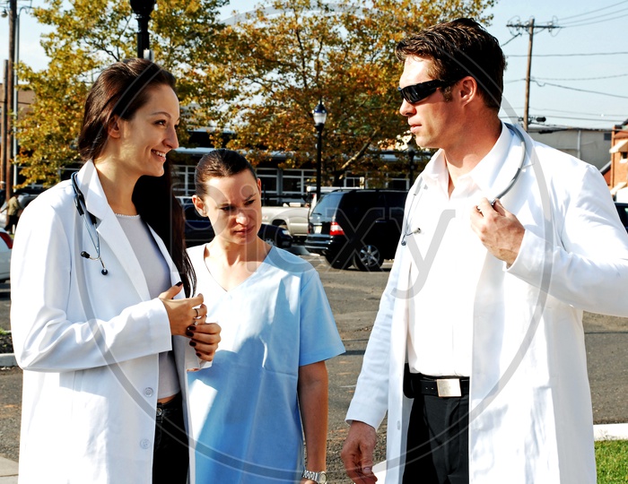 Young male and female doctors with a female nurse on the road