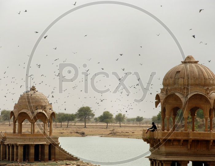 A man standing on dome shaped pavilion in water