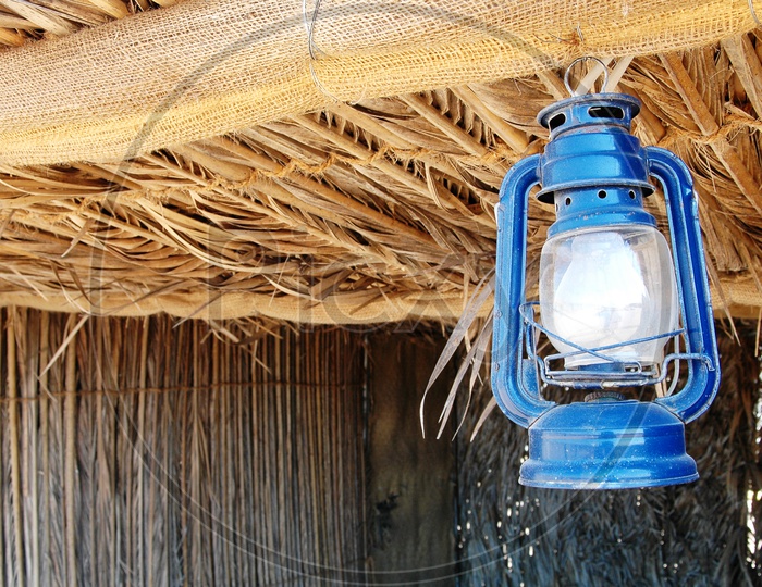 Blue lantern hanging onto a roof