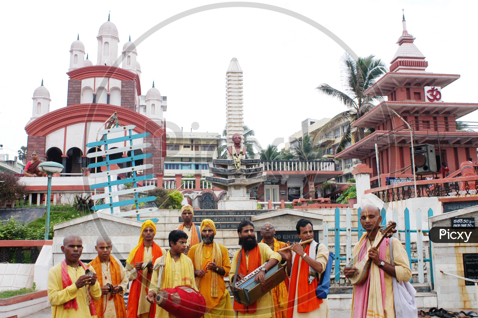 Devotees with musical instruments in front of a temple
