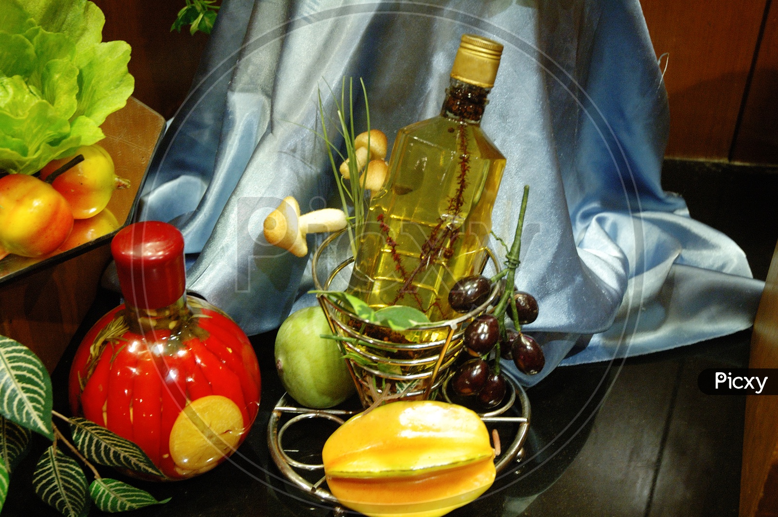 Artificial fruits and a glass bottle