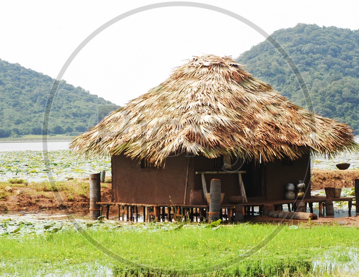 Thatched mud hut near a river