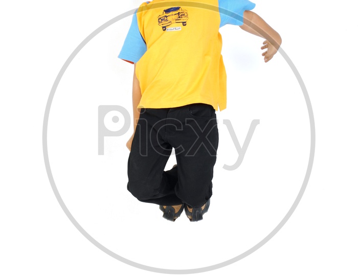 An Indian boy jumping in white background