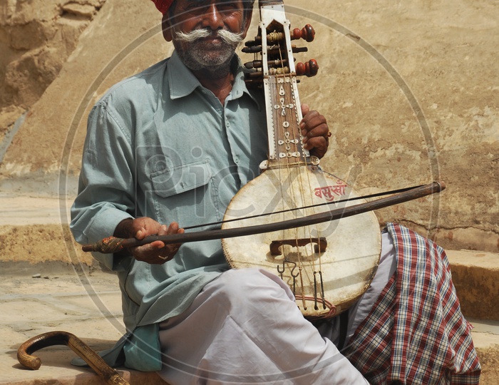 Rajasthan man playing musical instrument
