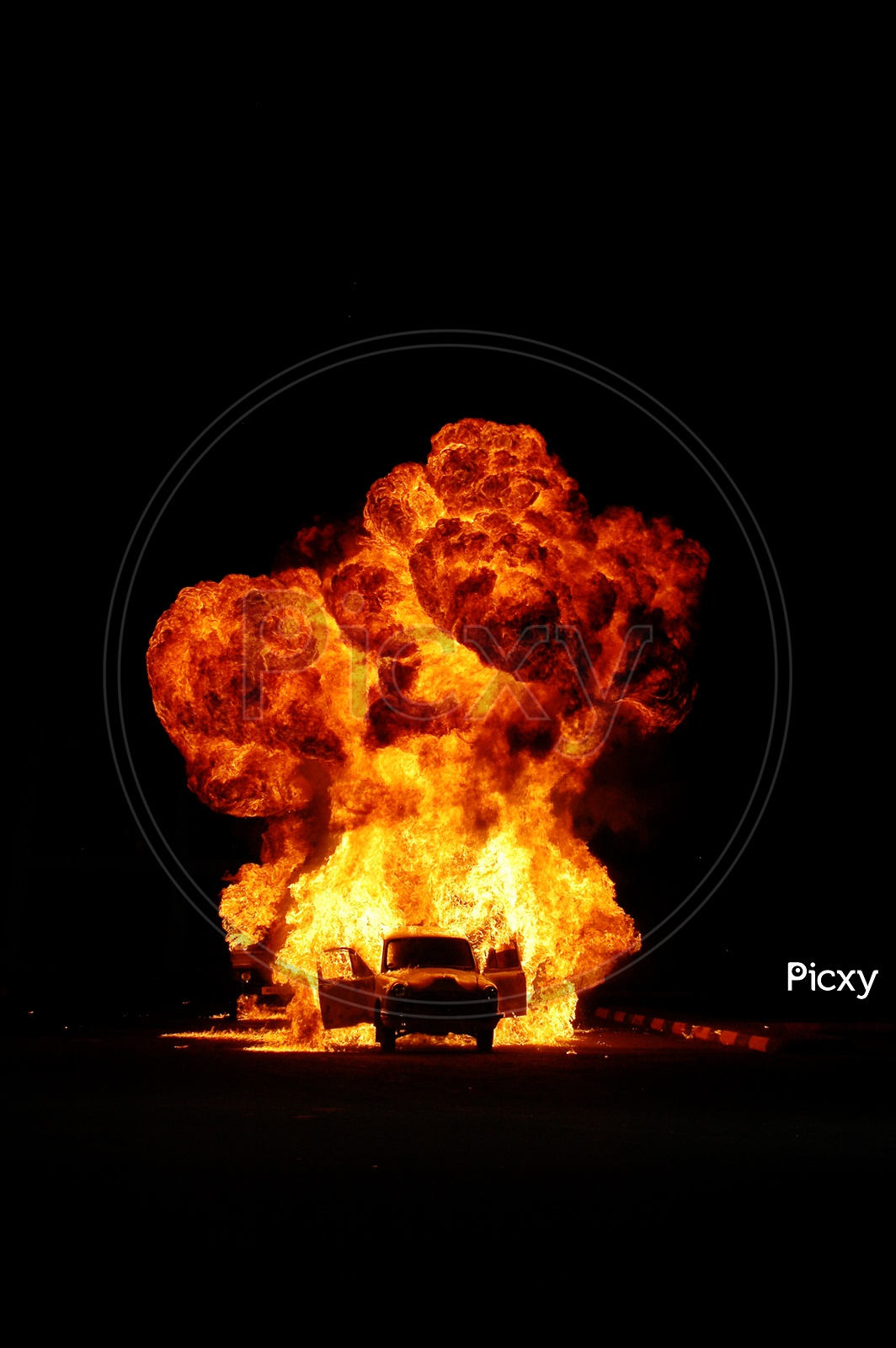 Image of Car bomb blast on road during nightRT942251Picxy